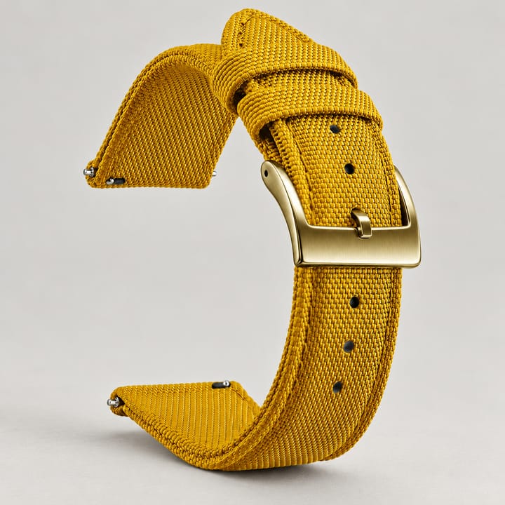 The Halyard woven nylon watch band in marigold yellow with a gold-tone buckle and quick-release spring bars