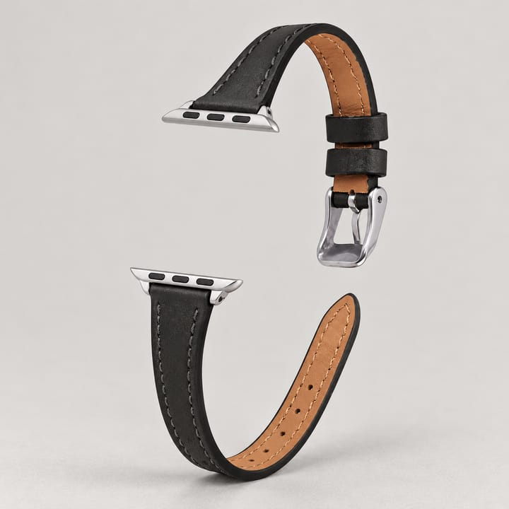 The Ribbon in Black on a watch, with a silver-tone buckle
