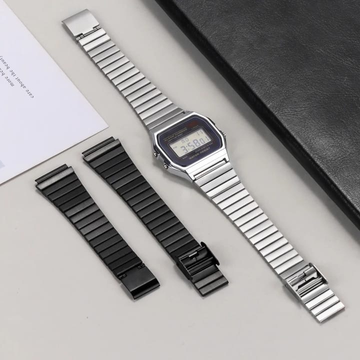 Silver band on a square digital watch, with the black band beside it