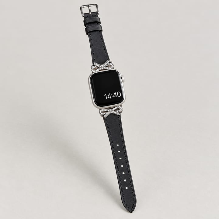 The Atelier in Black, held in the hand, with a rhinestone bow at each end of the case
